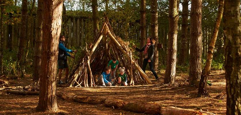 Family building a den in the forest