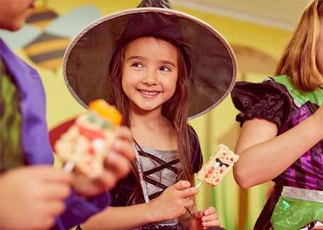 A little girl in fancy dress as a witch.