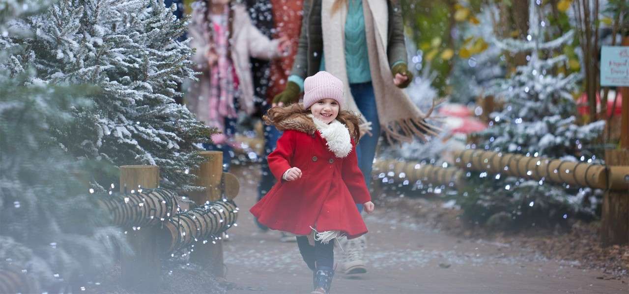 A little girl walking through the Winter Village.