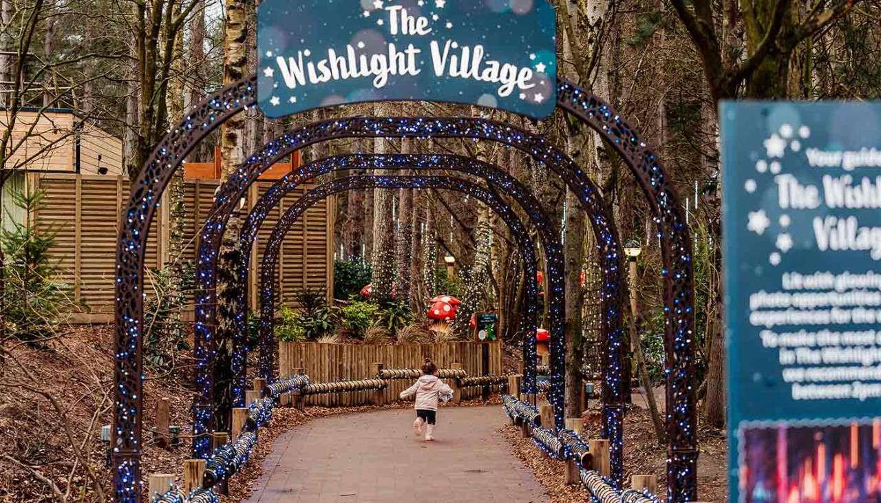 Little girl running through the Wishlight Village.