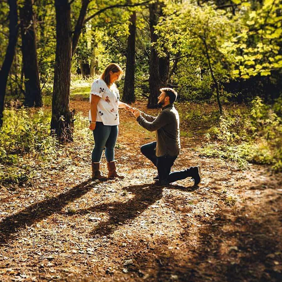Man proposing to his partner in the forest.