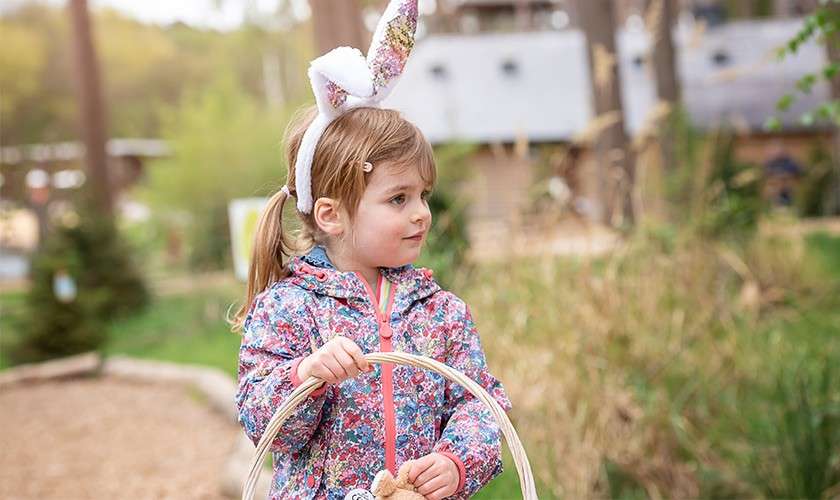 A girl holding her Easter egg basket whilst on the Easter Egg Hunt.