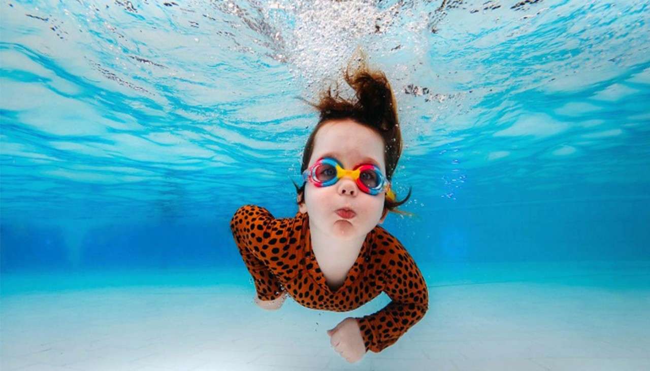 A child swimming under water in The Subtropical Swimming Paradise.