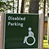 A sign showing the direction for disabled parking.