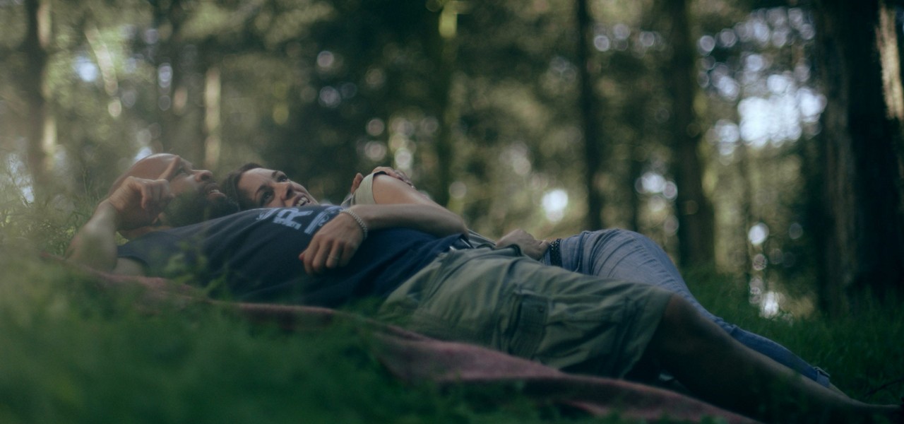 A couple lying peacefully on the forest floor