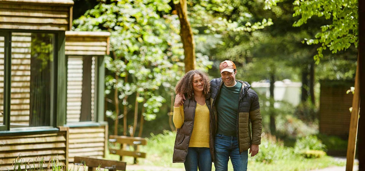 A couple walking through the forest together