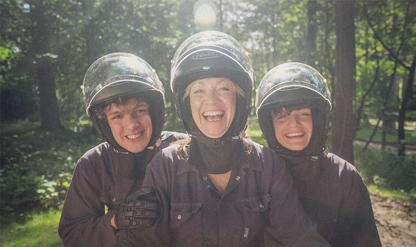 A family taking a selfie ready to go on the Quad Bikes.