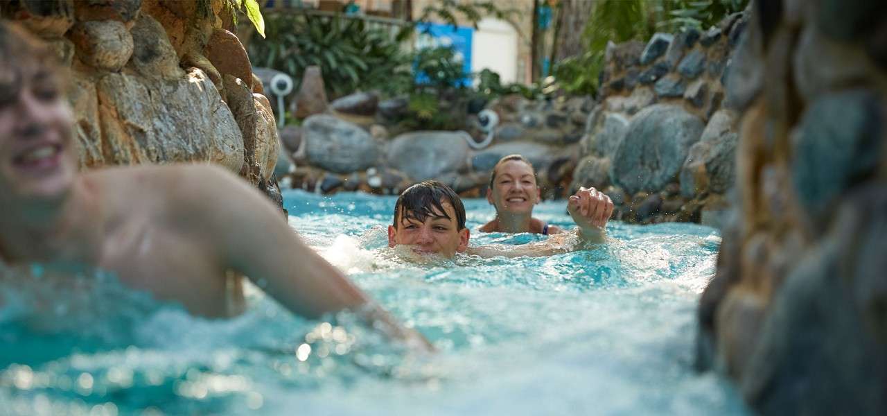 Family in the rapids at the subtropical swimming paradise