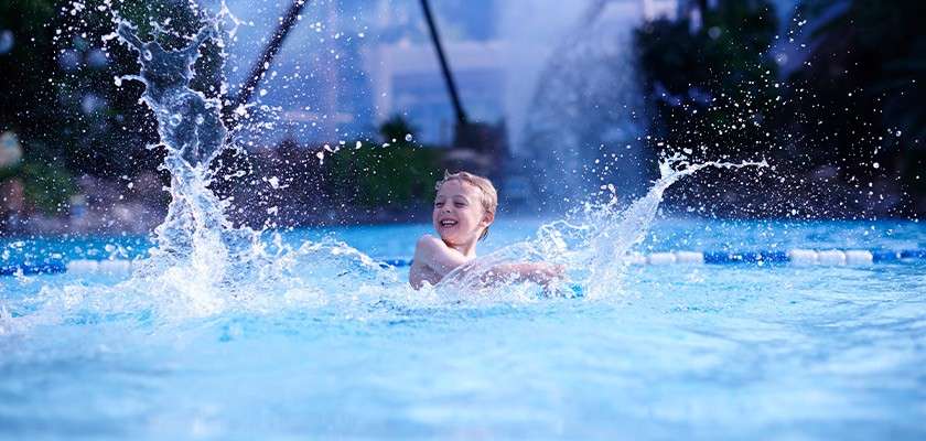 A boy splashing around in the Subtropical Swimming Paradise
