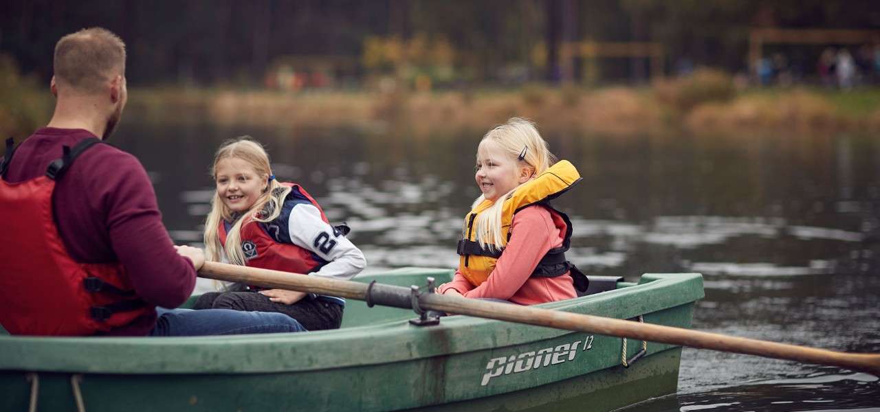 Two girls and their dad in a boat