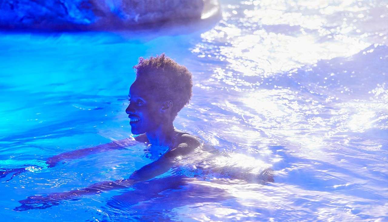 A lady swimming outside.