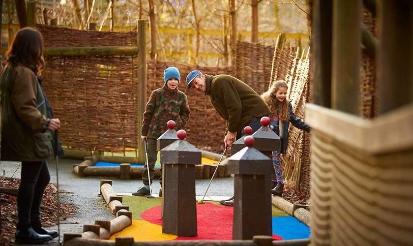 A family playing adventure golf together.