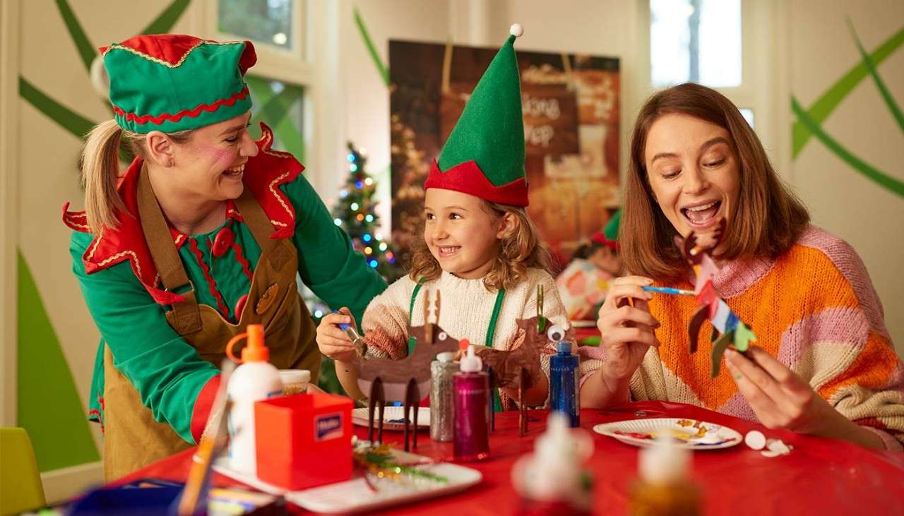A family enjoying activities with the elves.