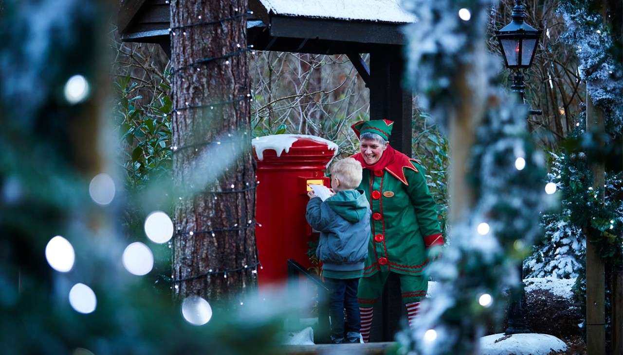 A little boy posting a letter to Santa