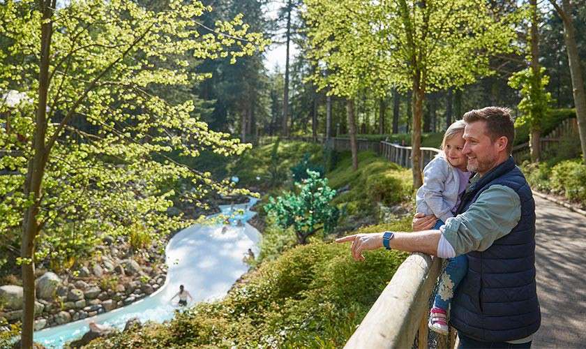 Father and daughter looking over at the Subtropical Swimming Paradise slides.