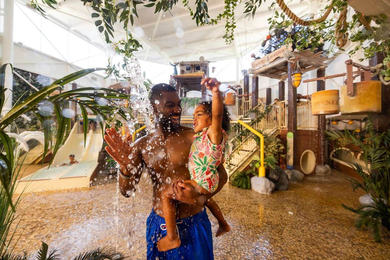 Father and daughter splashing in the Subtropical Swimming Paradise.