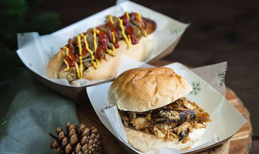 A burger and a hot dog that you can buy from the Winter Wonderland Forest Fayre 