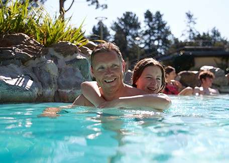 Young lady with young child on bicycle.
