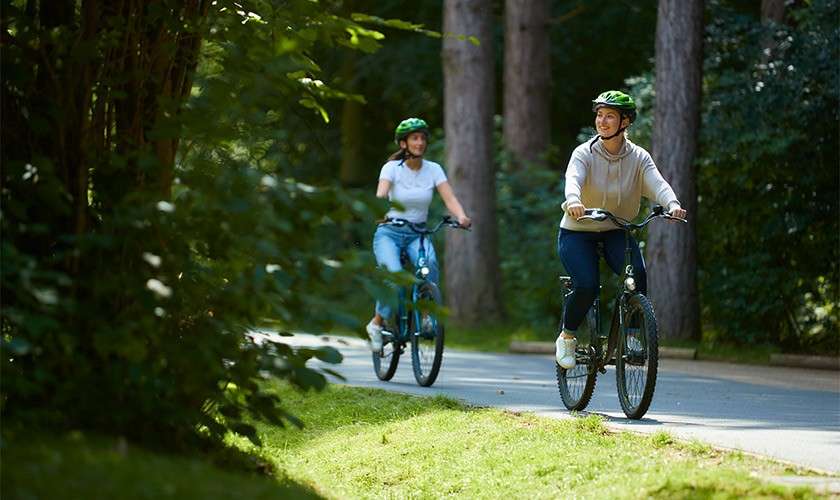 Mother and daughter cycling in the woods