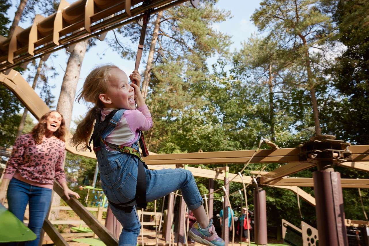 A toddler going down a slide