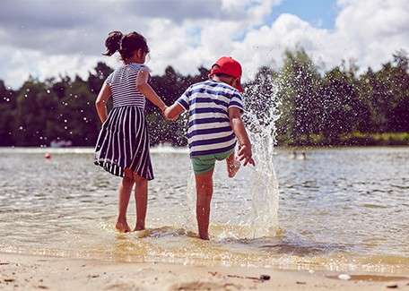 Children play in the water on the beach