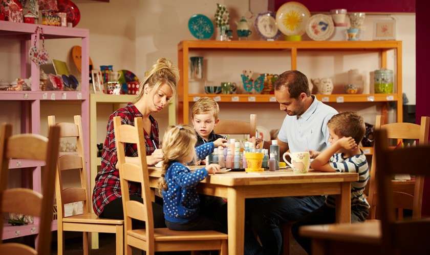 A family painting pottery together.