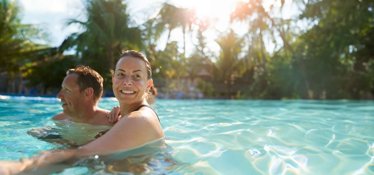 An adult couple swimming in the Subtropical Swimming Paradise.
