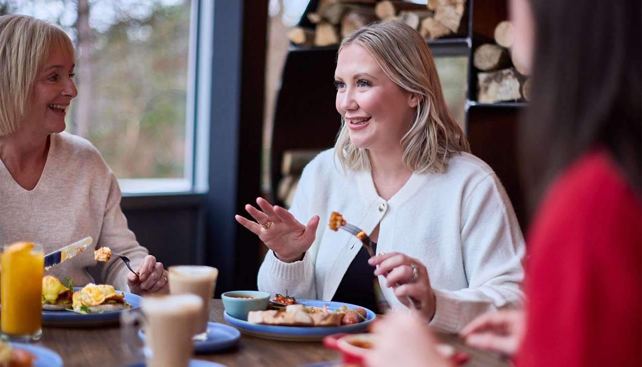 Adults enjoying a meal in the Dozing Duck.
