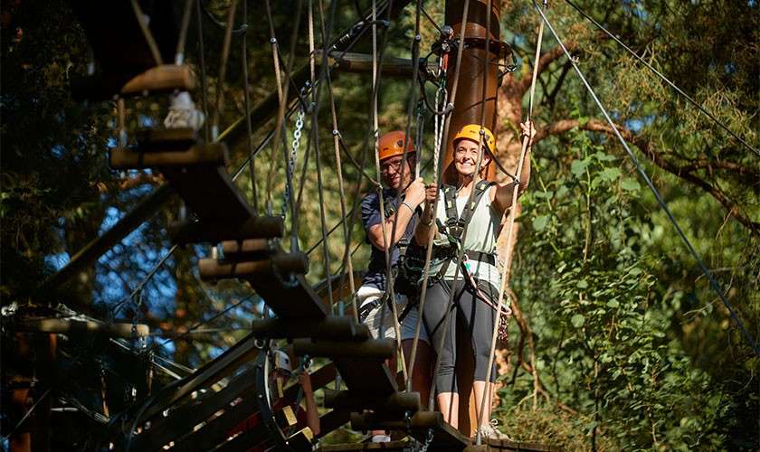 A couple trekking through the treetops