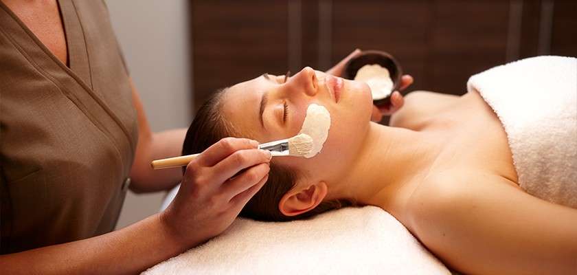 A woman receiving a face mask treatment at Aqua Sana.