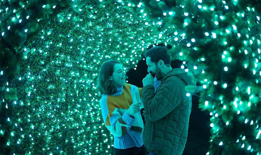 A couple surrounded by fairy lights