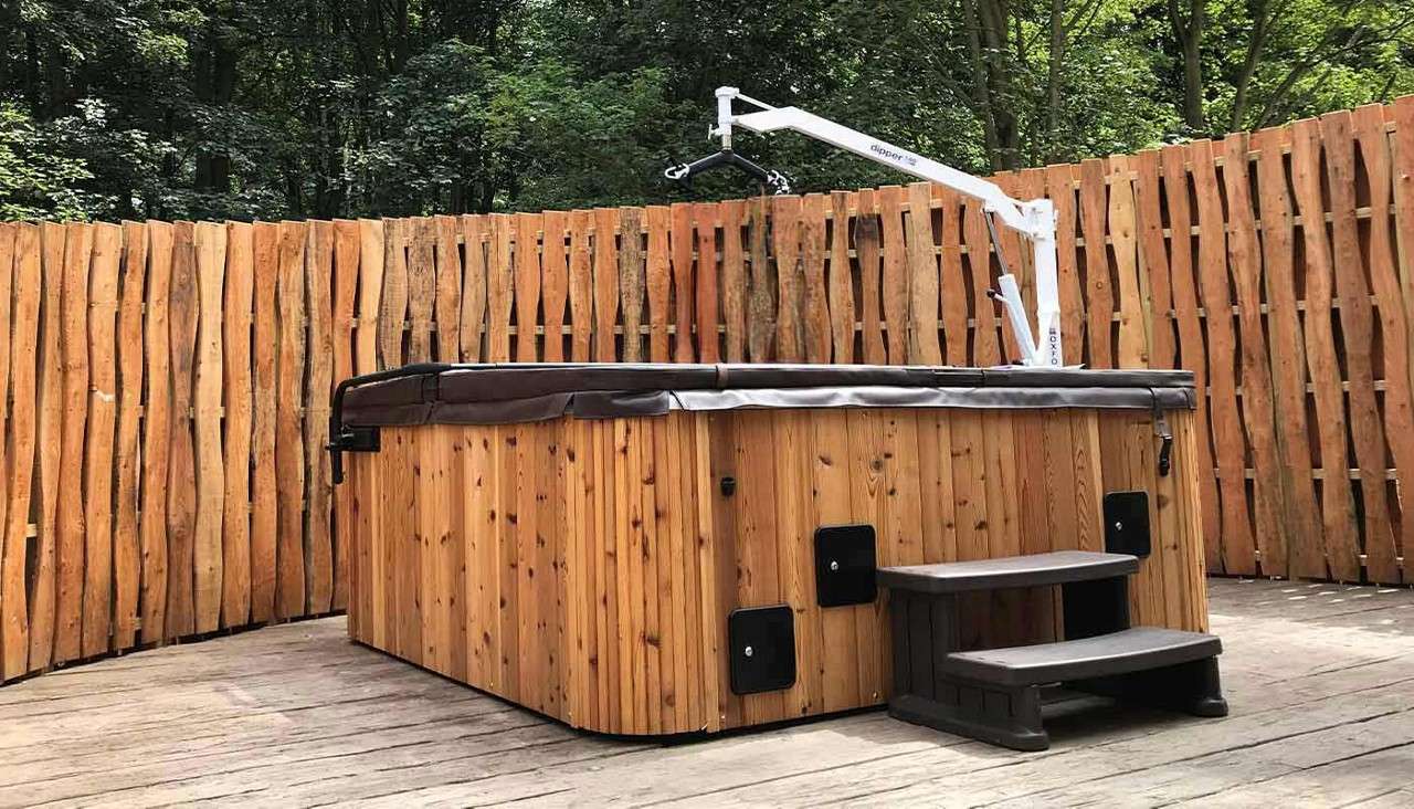 Hot tub with lifting arm for assistance.