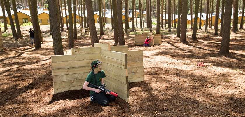 A child hiding behind an obstacle on the Laser Combat course