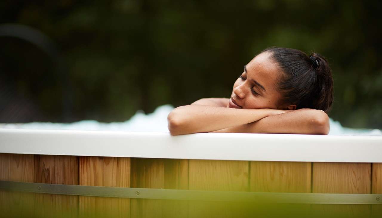 A woman in an outdoor hottub 
