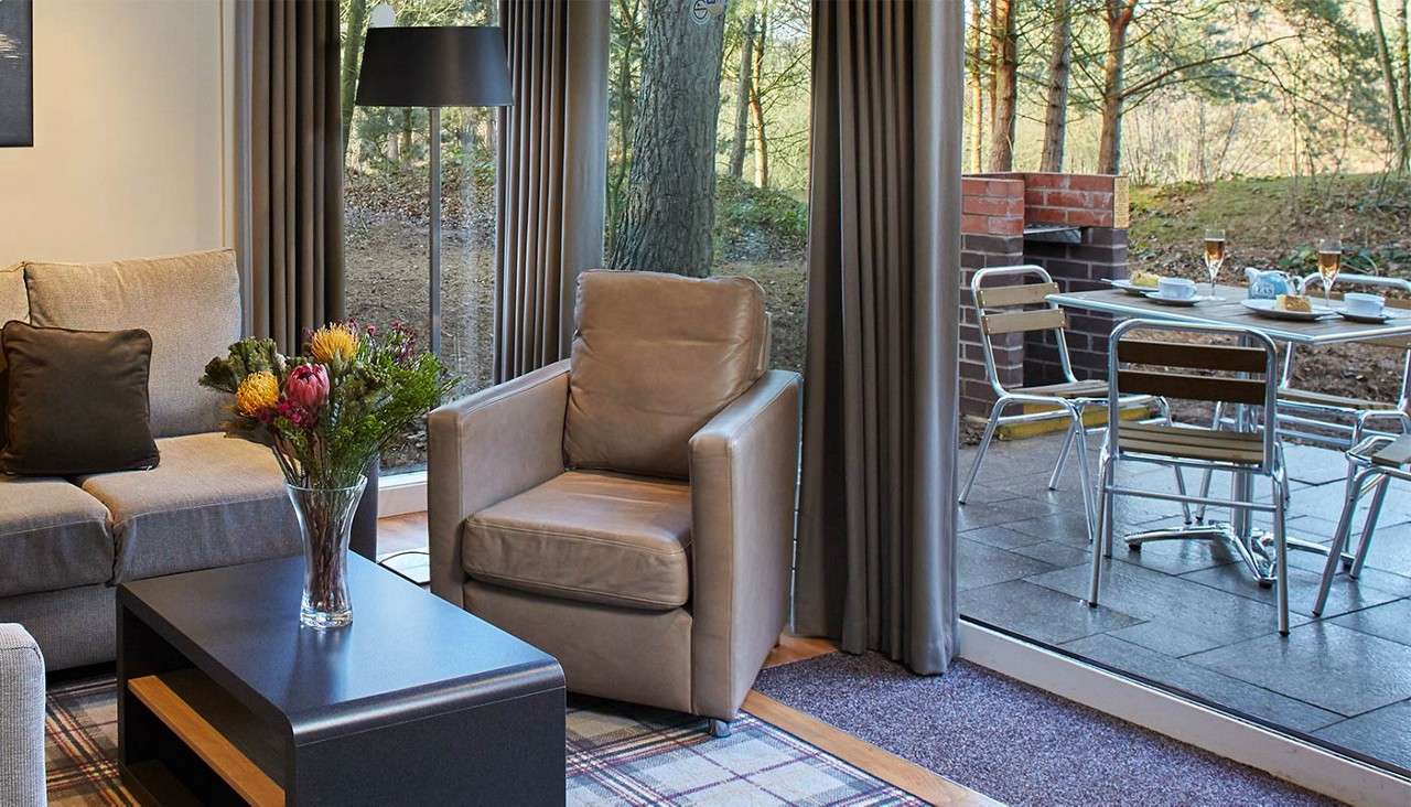 Lounge area in lodge with a vase of flowers on coffee table