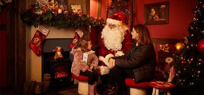 A mother and her daughter sat with Santa.