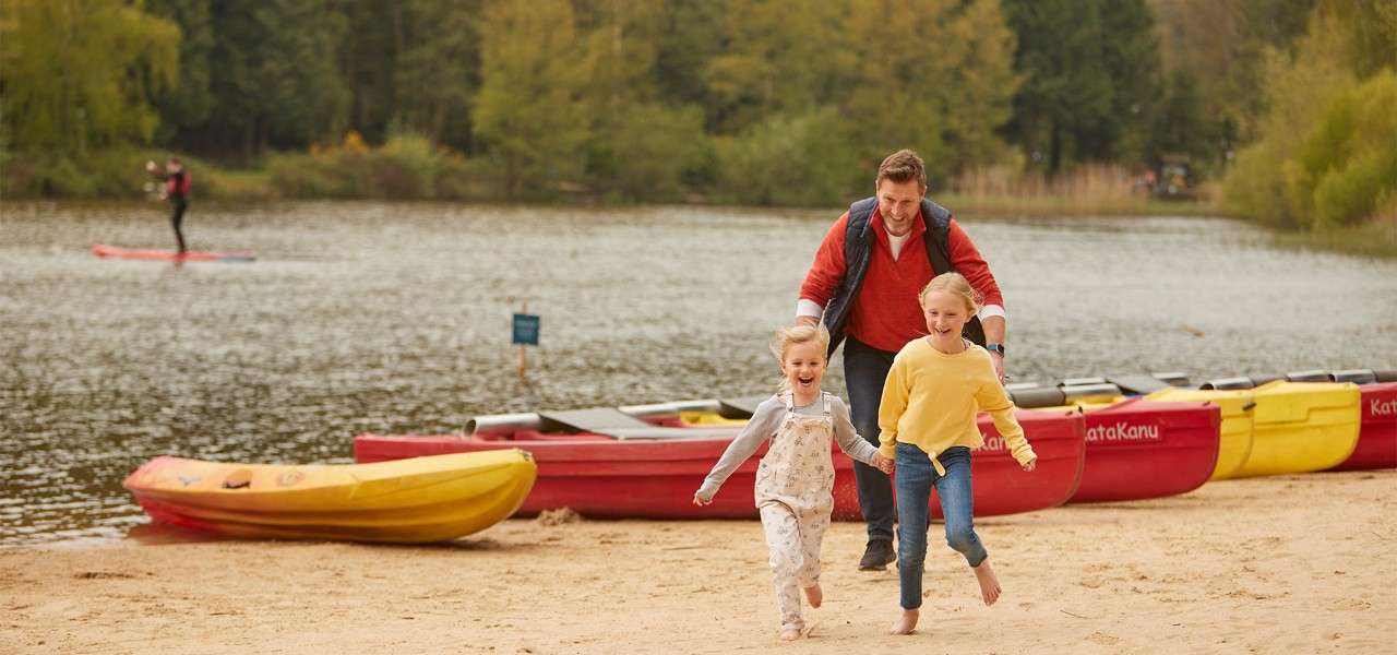 Center Parcs staff member in life jacket with trees behind him 