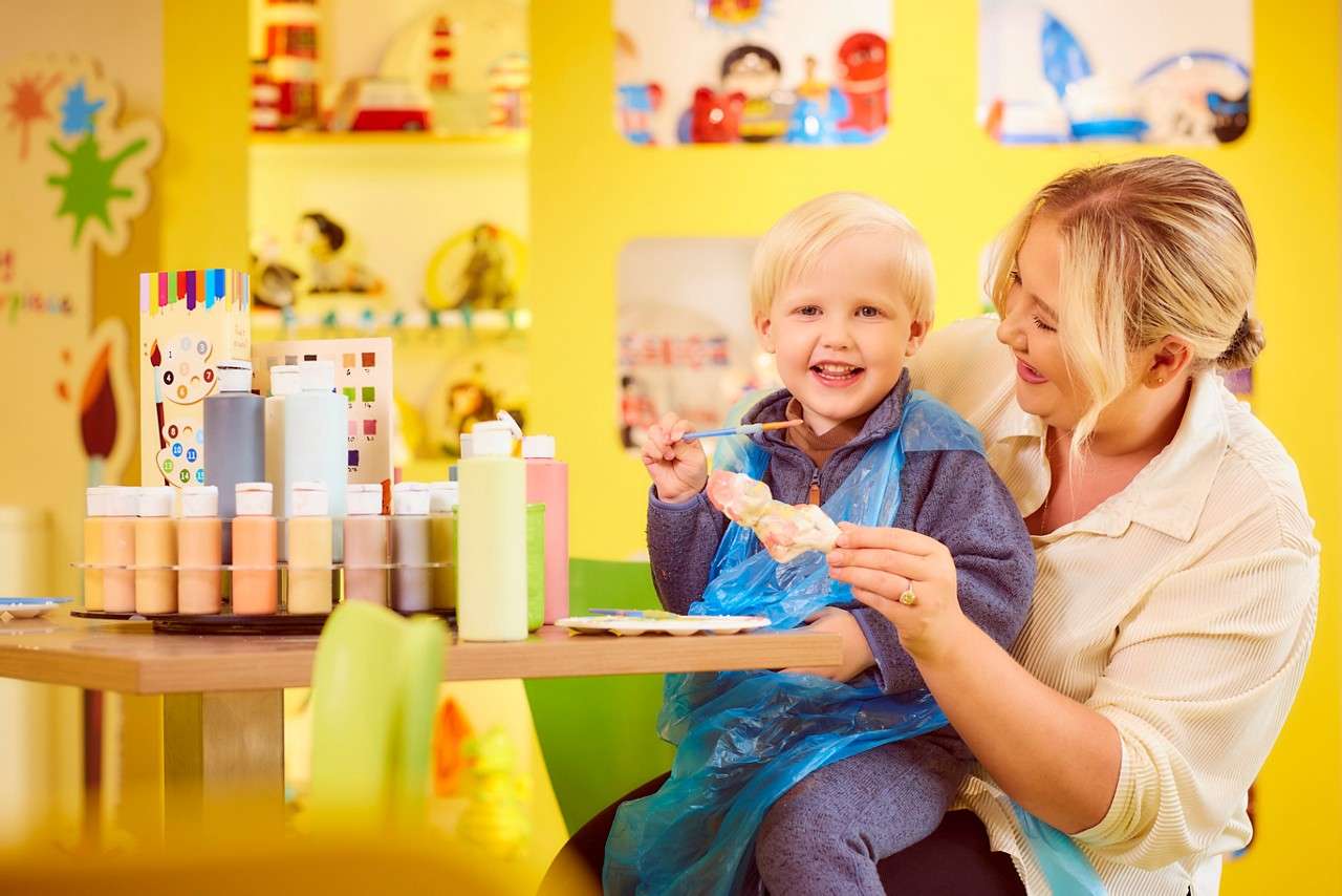 Family running down a woodland trail.