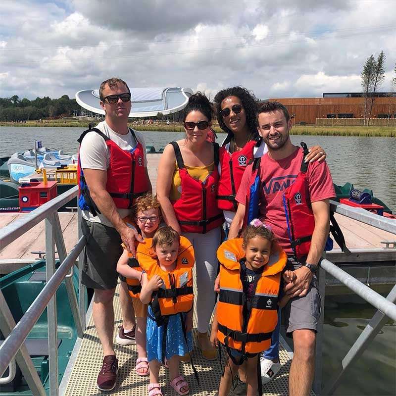 Family wearing life jackets ready to take to the lake.