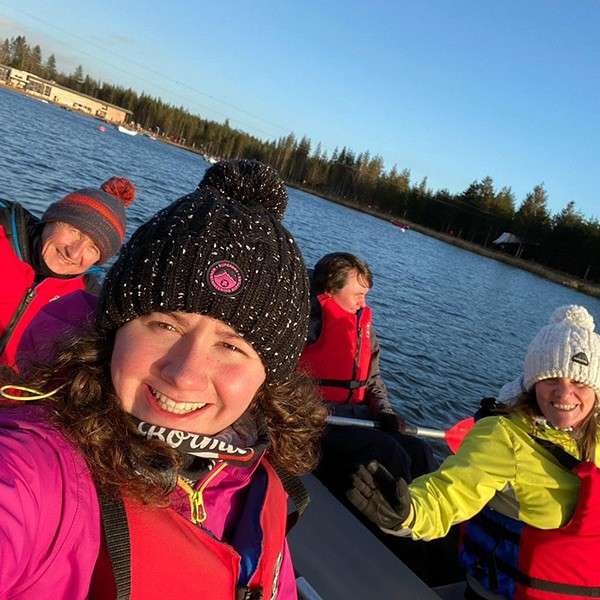 Group of people in an Electric Boat on the lake.