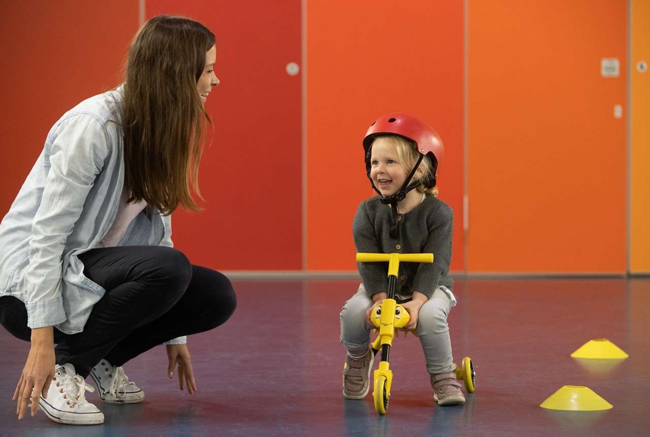 Young person on a mini trike.
