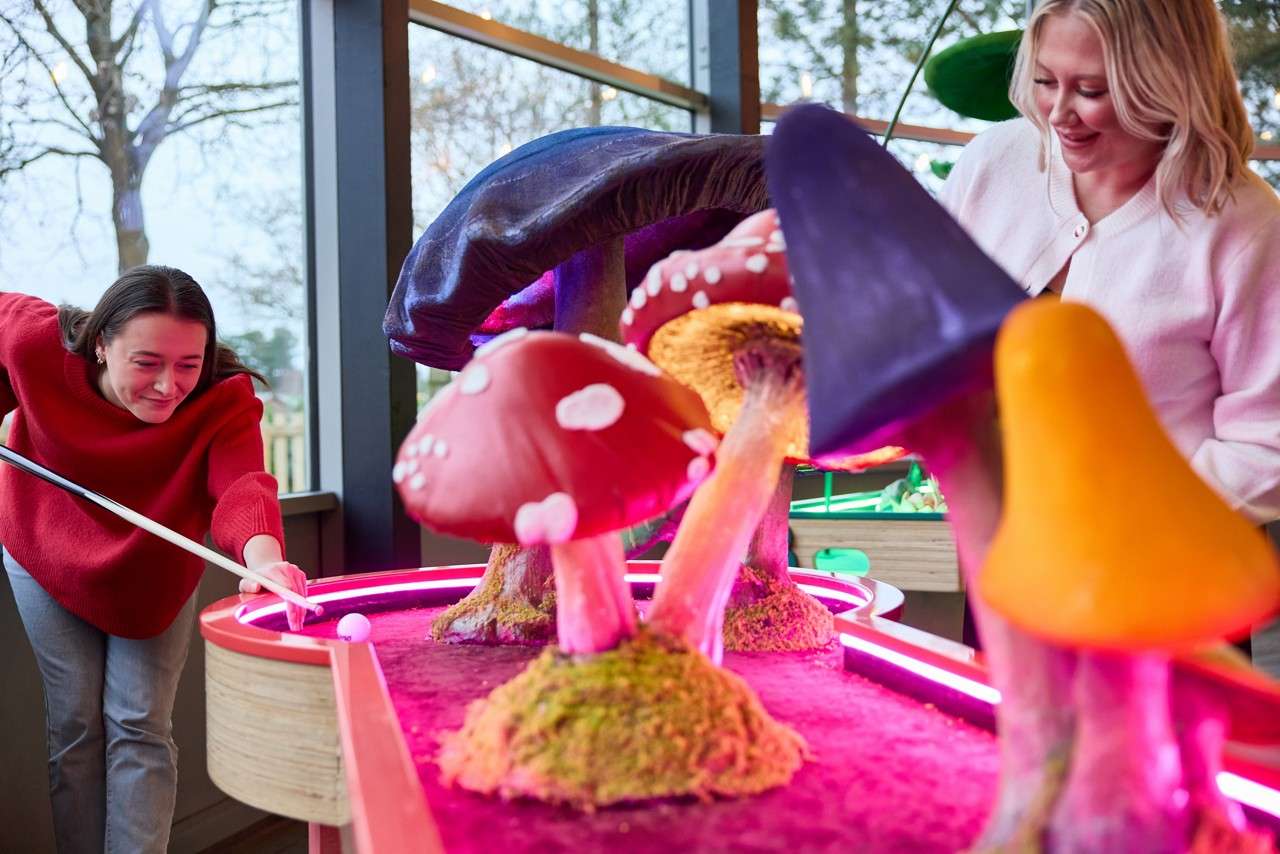Crazy Pool table with giant mushrooms and glowing lights.