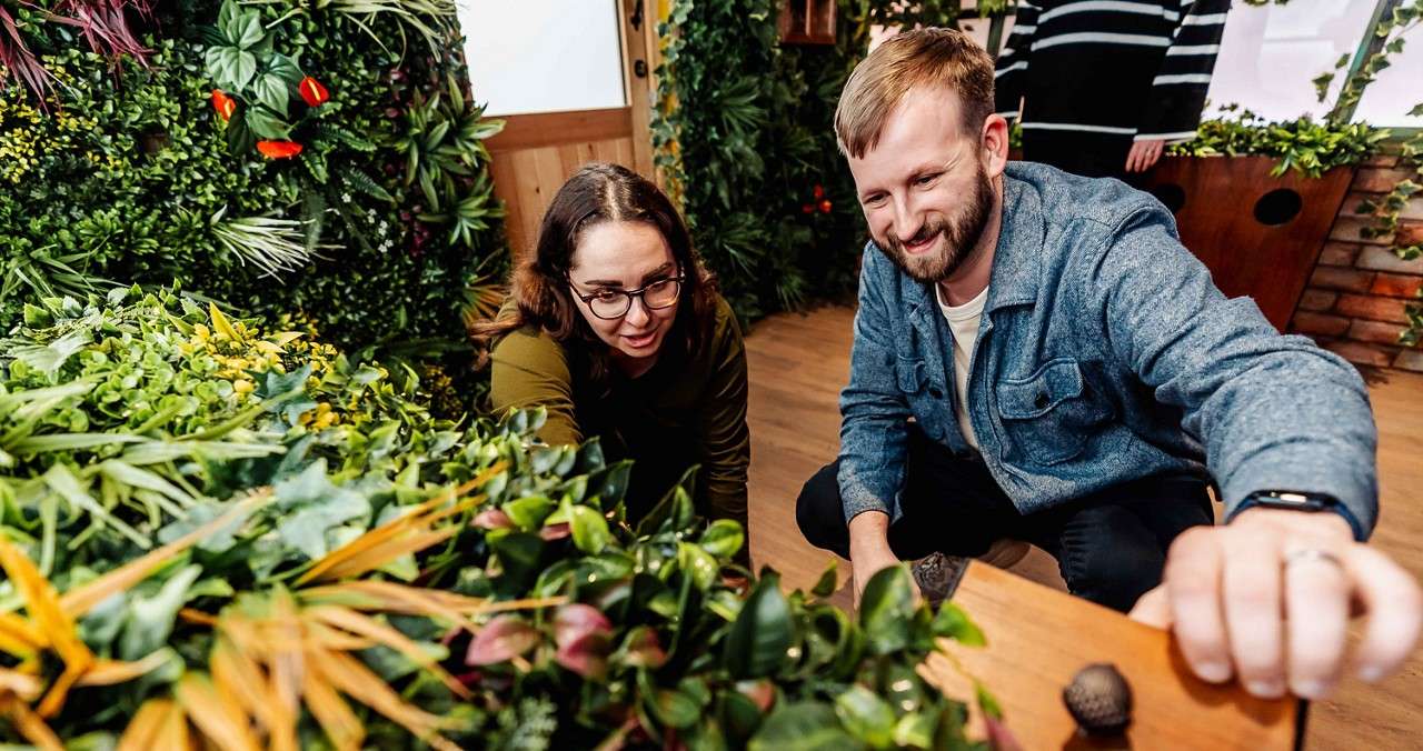 Two people looking for clues in an escape room.