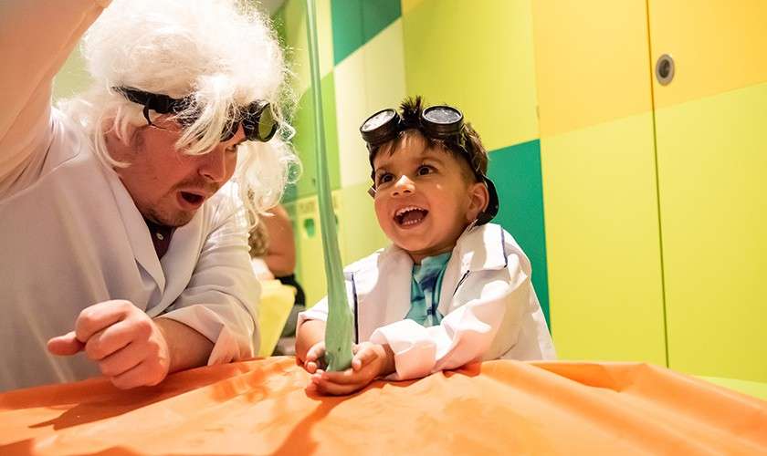 A little boy playing with slime during Spooky Science.