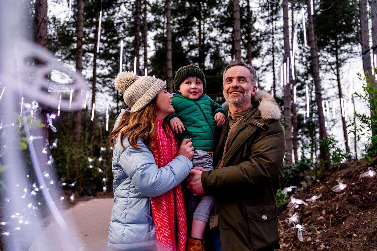 Family walking down the Enchanted Light Garden.
