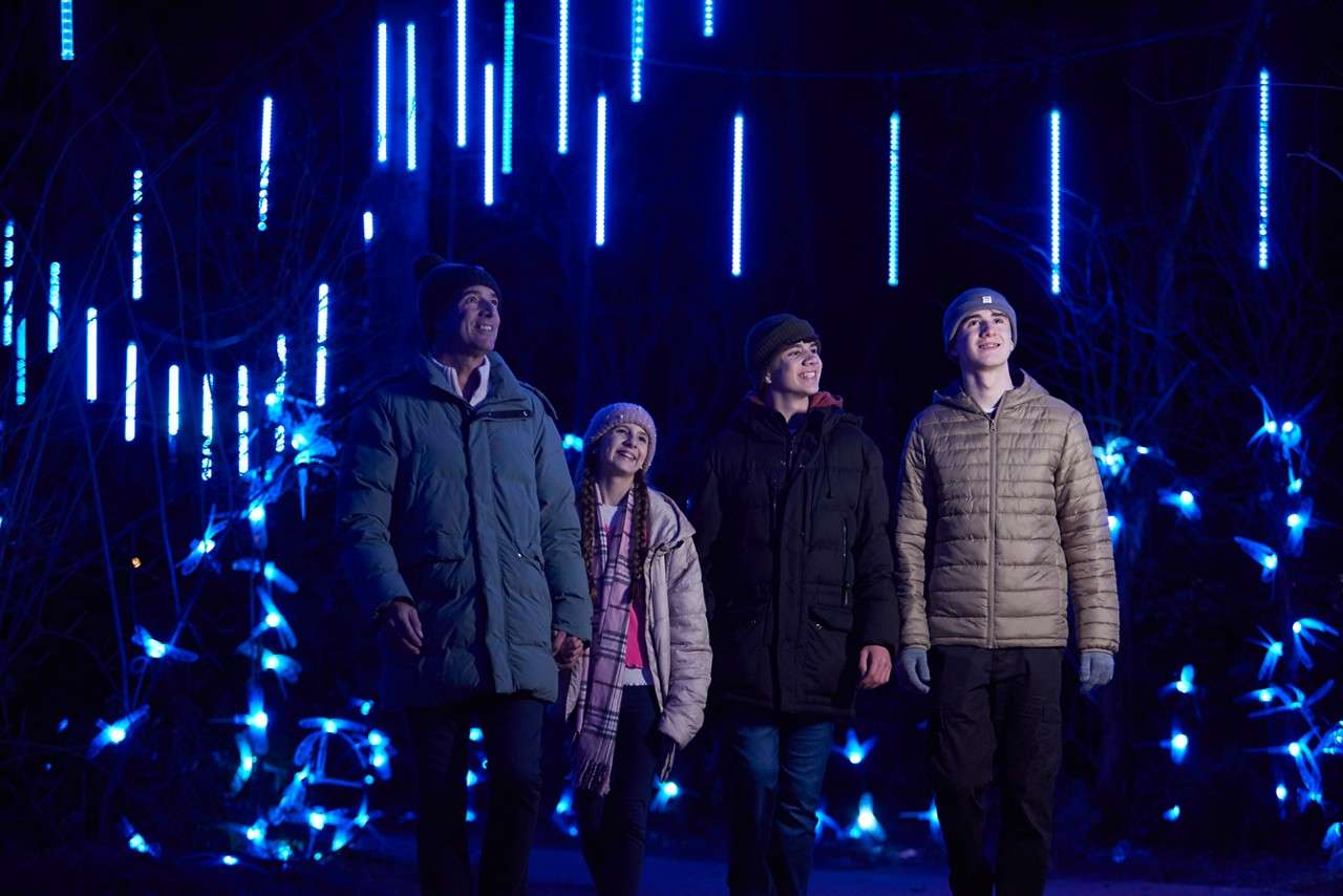 Family walking through the Enchanted Light Garden.