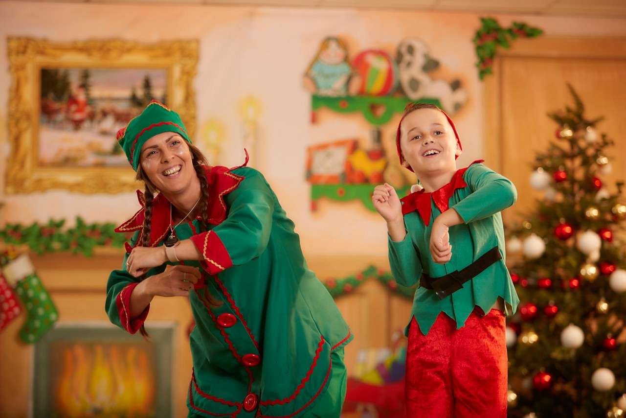 Two elves dancing in the snow.