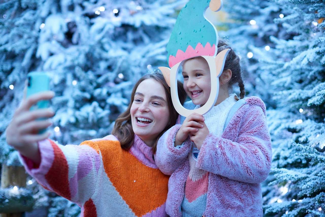 Woman and a young girl taking a selfie.