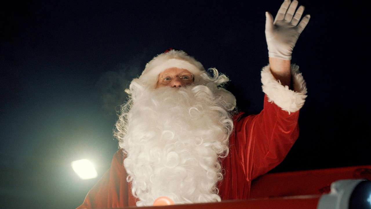 Santa waving from his sleigh.