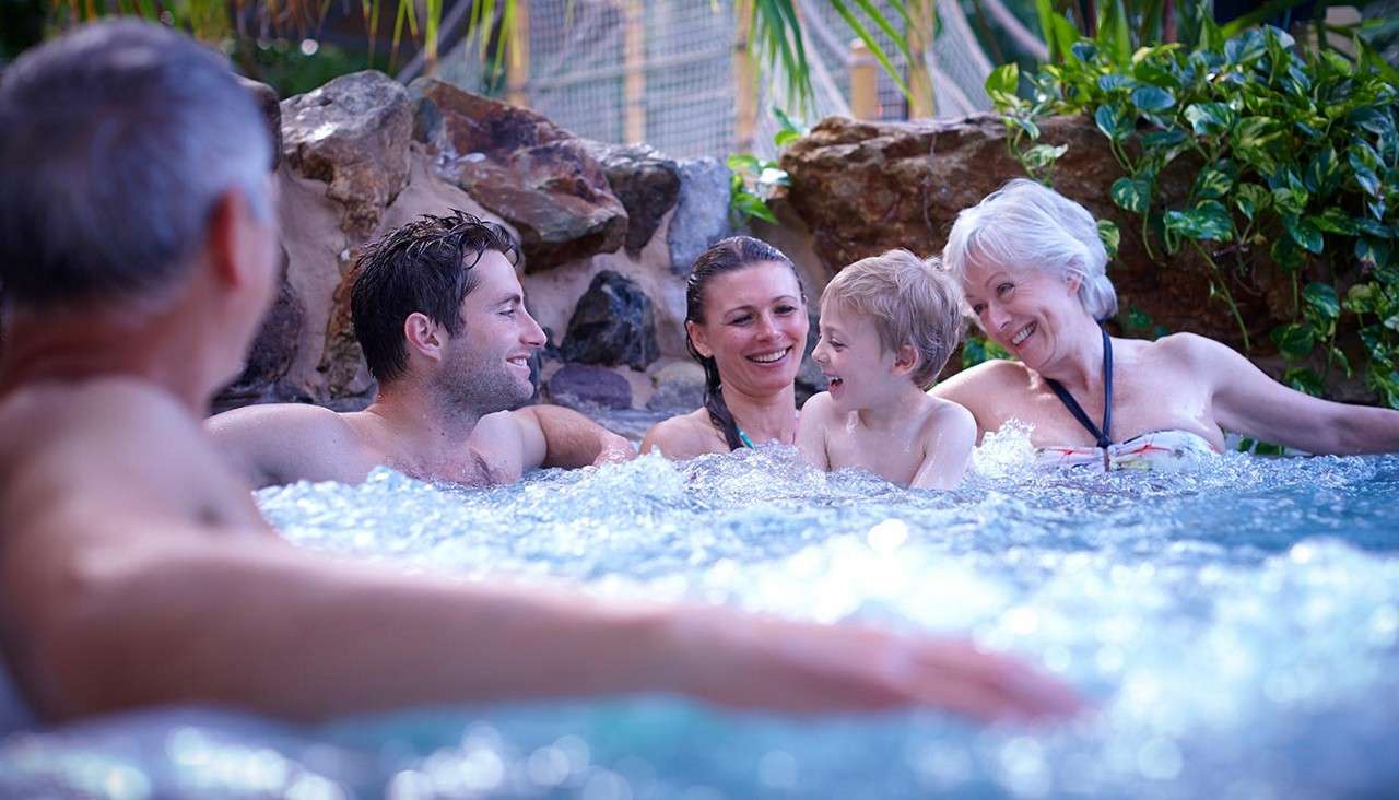 Family soaking in a bubbling whirlpool.